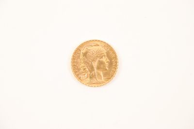 a close up of a gold coin on a white surface