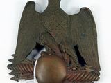 an eagle that is sitting on top of a ball