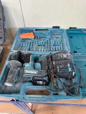 a blue tool box with tools in it on a table