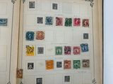 an open book with stamps on it sitting on a table