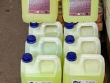 several gallons of liquid sitting on top of a wooden pallet