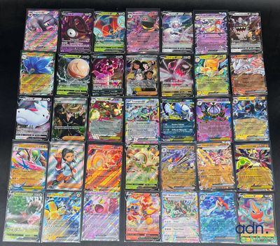 a large collection of pokemon cards sitting on top of a table