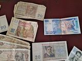 many different bank notes laid out on a table