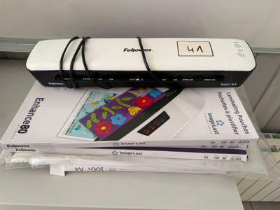 a printer sitting on top of a stack of books
