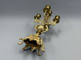 an image of a gold plated candle holder with a clock on it