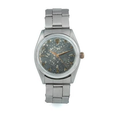an image of a wrist watch with a star pattern on the dial