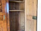 a wooden cabinet with a door open on a white background