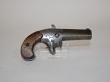 an old gun with a wooden handle on a white surface