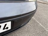 a close up of a black car with a number plate on it