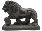 a statue of a lion with a ball in it ' s mouth