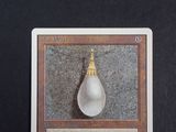 a picture of a card with a picture of a tear hanging from it