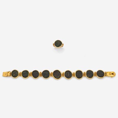 a gold bracelet with black stones