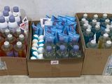 bottles of water and toothbrushes in boxes on a counter