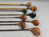 several different types of golf clubs are lined up on a table
