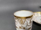 a cup and saucer sitting on a table