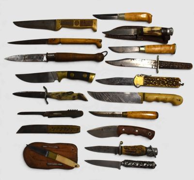 many different types of knives on a white surface