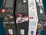 four boxes of lego star wars action figures on display