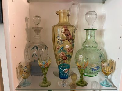many glass vases and glasses on a shelf