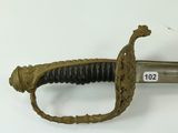 an old sword is displayed on a white surface with a tag on it