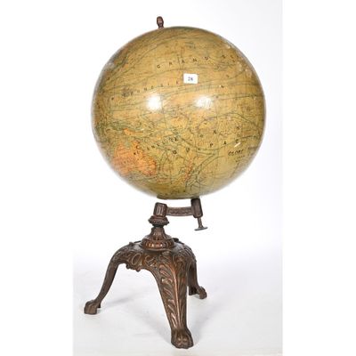 an antique globe on a stand with a white background