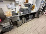 a large kitchen with a lot of food on the counter