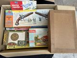 a cardboard box filled with assorted items on the floor