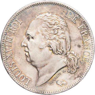 Gros plan sur une pièce de monnaie portant le visage d'un homme