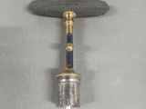 an image of a small metal object with a wooden handle