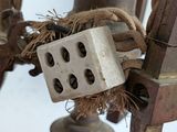 a close up of a metal object with a block attached to it