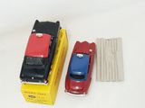 a red car and a blue car next to a yellow box