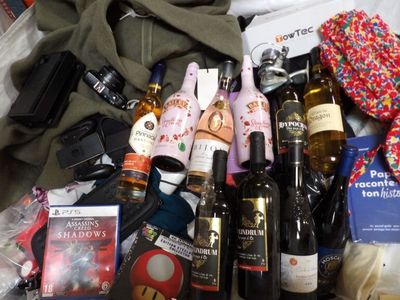 many bottles of wine, books and other items on the bed