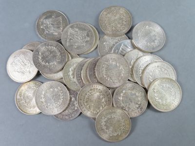 pile of silver coins sitting on top of a gray surface