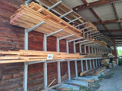 many wooden planks stacked on the shelves in the warehouse