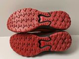 the soles of a pair of red shoes on a white surface