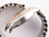 a close up of a watch with a chain around it