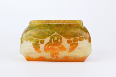 un vase en verre avec un motif sur une surface blanche