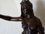 a statue of a woman holding a bird in her hand
