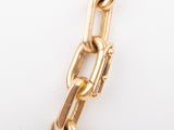 an image of a close up of a gold chain on a white surface