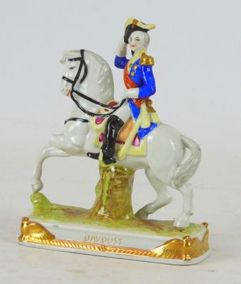 a figurine of a man riding a horse