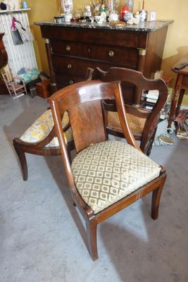 a chair and a table in a room with a dresser