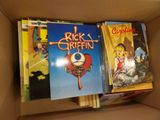 many books in a cardboard box on the shelf