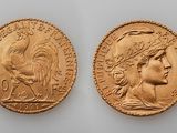 two gold sovereigns, one of which has a head of a woman and one of which has a head