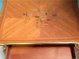 a small wooden table with a drawer underneath it