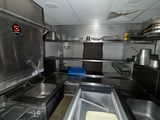 an image of a commercial kitchen with a lot of counter space