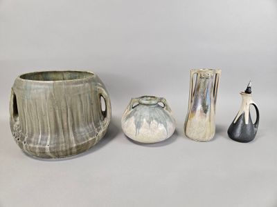 four different vases and a vase on a table