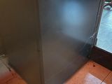 a silver refrigerator sitting in front of a glass door