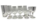 a group of wine glasses that are lined up together