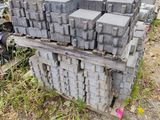 a pile of bricks sitting on the ground in front of a building
