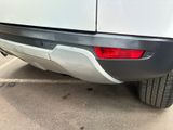 a white van parked in a parking lot next to a building