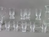 a lot of glasses and a pitcher sitting on a table